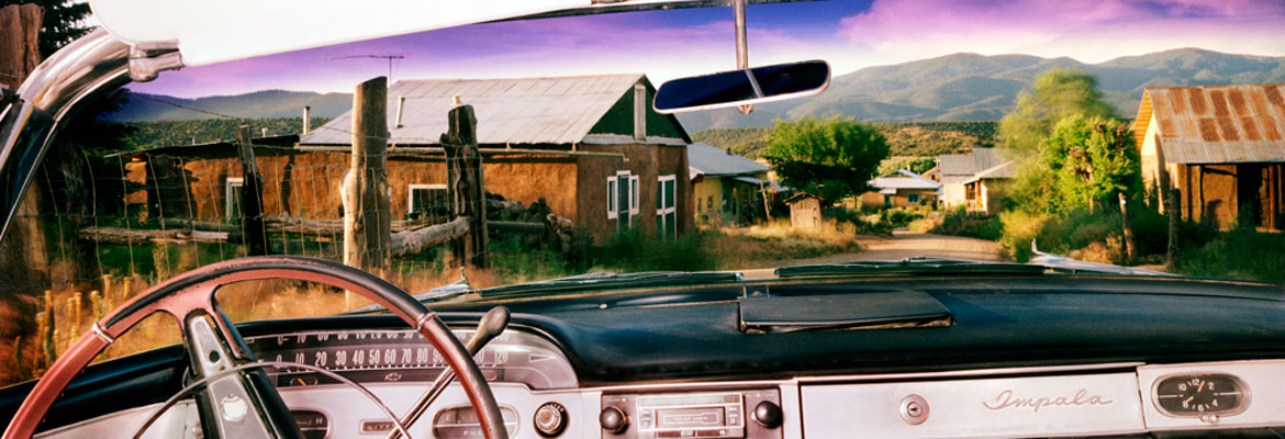 Chamisal, New Mexico, looking north from Juan Dominguez's 1957 Chevrolet Impala, July, 1987, Photograph by Alex Harris - WEBSTER COLLECTION